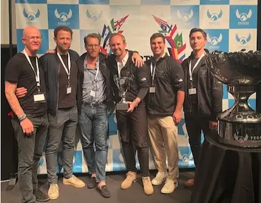 Treasure team standing with Startup cup